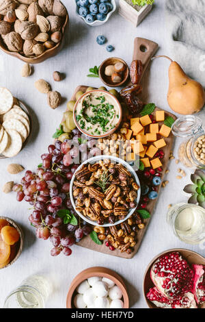 Eine Schüssel mit würzigen kandierten Pekannüsse werden fotografiert, als ein Teil des Brettes Käse und Obst. Stockfoto
