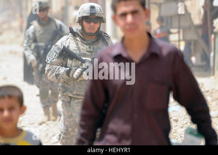 US Armee Sgt. Anthony Zapata aus Corpus Christy, Texas, der 2. Zug, A Company, 2. Bataillon, 505. Fallschirm-Infanterie-Regiment, 3rd Brigade Combat Team, 82nd Airborne Division, bewegt sich auf der Straße bei Assessments von zivilen Verbesserungsprojekte in Muhallahs 760 und 762, östlichen Bagdad, Irak, am 21. Juni 2009. Die Projekte umfassen Marktgebiete, Straßenpflaster und lokalen Kanalisation zu verbessern. Fallschirmjäger, nationale Polizei patrouillieren Oubaidy 181476 Stockfoto