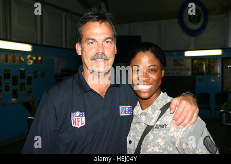 SPC. Laura Johnson, ein Fotojournalist mit 211. Mobile Public Affairs-Abteilung, Abteilung spezielle Truppen Bataillon, 1. Kavallerie-Division, bekommt eine Umarmung von NFL Cheftrainer Jeff Fisher die Tennessee Titans am Camp Liberty 4 Juli.  Für Johnson, ein Eingeborener von East Orange, New Jersey, der Moment war etwas besonderes - ihr jüngerer Bruder Kenny Britt ist ein Rookie Wide Receiver mit den Titanen. Fisher war im Camp Liberty US-Truppen im Rahmen der USO geförderte NFL Trainer Tour besuchen. NFL Trainer Tour besucht Multi-National Division - Bagdad 185080 Stockfoto