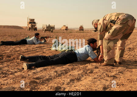 Eine irakische Polizisten erhält Anleitung, wie man richtig sein Gewehr aus der Bauchlage beim AK-47 Bereich Training unter der Leitung von US-Soldaten aus der 218. Military Police Company in Mammah, Irak, Aug. 30 Feuer. Bereich Sicherheit 200517 Stockfoto