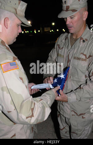 GUANTANAMO BAY auf Kuba – Küstenwache Petty Officer 3rd Class Travis Smith und Petty Officer 1st Class Kevin Knutsen mit Joint Task Force Guantanamo Falten eine amerikanische Flagge nach überfliegen des naval Basis, 11. September 2009.  JTF Guantanamo Soldat innen flog mehr als 70 Fahnen, darunter eine für jede Familie, die einen Angehörigen auf United Airlines Flug 93 verloren, die stürzte in Shanksville, Pennsylvania, 11. September 2001.  JTF Guantanamo führt sicher, humane, rechtliche und transparente Pflege und Obhut der Gefangenen, einschließlich der Militärkommission und die verurteilten bestellt von einem Gericht freigegeben. JTF-c Stockfoto