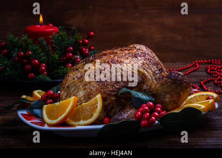 Ganze Brathähnchen mit Weihnachtsdekoration. Hölzerne Hintergrund. Stockfoto