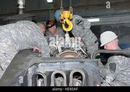 Keine Angst, seine Hände schmutzig machen, Command Sergeant Major Frank Grippe (schwarzen Helm), Befehl Sergeant-Major des i. Korps, Bagdad, Irak, hilft Soldaten von Firma B, 615th Aviation Support Battalion, 1. Luft-Kavallerie-Brigade, 1. Kavallerie-Division, US-Division - Center, senken Motor zurück in ein AH - 64D Apache Kampfhubschrauber während eines 18. Februar zu besuchen. Grippe, sprach mit dem Air Cav senior Soldaten angeworben, sondern sprach auch mit den jüngeren Soldaten drehen den Schraubenschlüssel. (Foto: U.S. Army Staff Sgt. Nathan Hoskins) Air CAV beherbergt das Korps I CSM 252645 Stockfoto