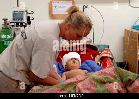 Eine niederländische Krankenschwester arbeitet mit einem afghanischen Kind, das vom Dach fiel. Der junge wurde in Tarin Kowt freuen uns OP-Team um Hilfe gebracht. Niederländische besucht die FST für cross-Training mit US-Militärangehörige 11. November 2010. (Foto: US-Armee Generalmajor Paul Oliver) (Freigegeben) Operation Enduring Freedom 340042 Stockfoto