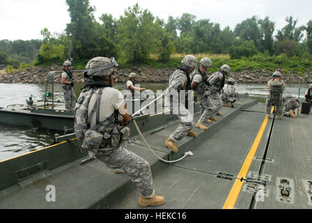 US Army Reserve-Soldaten von den 652nd Ingenieur-Unternehmen mit dem Sitz in Hammond, Wisconsin, USA, entfernen Sie Spannung in Brücke Buchten vor dem trennen sie am Arkansas River im Rahmen einer Fortbildungsveranstaltung am Fluss Angriff 2011 in Fort Chaffee, Arkansas, Juli 26. Fluss-Angriff gipfelte mit dem Bau einer schwimmenden verbesserte Menüband-Brücke über den Arkansas River. Überfall 2011 Brücke Flussüberquerung Stockfoto