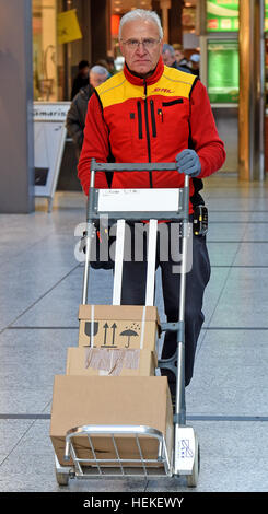 Die Paket-Zusteller Hans-Joachim Harnagel nimmt Pakete durch das Einkaufszentrum während einer Lieferung Runde Braunschweig, Deutschland, 21. Dezember 2016. Rund 280 Päckchen und Pakete liefern wir an ihre Empfänger während einer Reise durch die Innenstadt von Braunschweig. Foto: Holger Hollemann/dpa Stockfoto