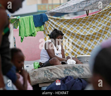 Florida, USA. 23. Dezember 2016. 011910 (Lannis Waters/The Palm Beach Post) PORT-AU-PRINCE, HAITI - eine Frau wäscht Kleidung in einem behelfsmäßigen Flüchtlingslager im Canape Vert Park eingerichtet. © Lannis Wasser/der Palm Beach Post/ZUMA Draht/Alamy Live-Nachrichten Stockfoto