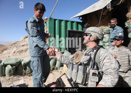 US Army Staff Sgt. Jeremy Longto, 19K-Rüstung Mannschaftsmitglied mit Alpha Company, 1. Bataillon, 172. Kavallerie-Regiment und Bradford, VT. Bewohner, schüttelt die Hand ein afghanischer nationaler Polizist, als er nach einem Besuch in den Außenposten, Charikar District, Parwan Provinz, Afghanistan geht. Longto und Fellow Troopers besuchen die ANP-Außenposten um eine plane zu verhindern, dass Regen undicht in ihre Wohnräume zu Spenden und besprechen Sie Sicherheit Kräfte Fragen, Okt. 23. (Foto: U.S. Army Spc. Kristina Gupton) Firma A trifft sich mit einheimischen Führern 334266 Stockfoto