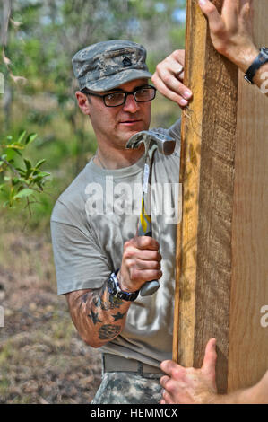 US Army Staff Sgt Michael Mastrangelo mit der 4th Infantry Brigade Combat Team, 25. Infanterie-Division, baut eine temporäre Ausbildungsstruktur für Talisman Saber 2013 bei Shoalwater Bay Truppenübungsplatz in Queensland, Australien, 18. Juli 2013.  Talisman Saber ist eine kombinierte Biennale Übung zwischen der USA und Australiens Streitkräfte entworfen, um beide Nationen Fähigkeit zur Reaktion auf regionalen Eventualitäten zu verbessern. (US Armee-Foto von Staff Sergeant Jeffrey Smith/freigegeben) Spartan Fallschirmjäger vorbereiten für Talisman Saber 2013 130717-A-ZX807-732 Stockfoto