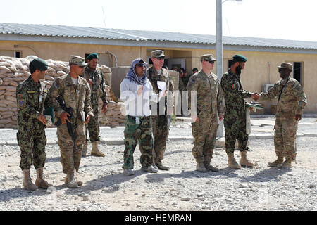 Afghan National Army Sergeant Saeydullah Mohammad Naeem, zweiter von rechts, mit der 4. Infanterie-Brigade 203. Korps ist gratulierte durch ein US-Army-Berater nach Abschluss des Kanoniers Digital Brand Richtung Master Kurs von US Armee-Beratern mit 76. Feldartillerie-Regiment, 4th Infantry Brigade Combat Team, 1. Bataillon, 3. Infanterie-Division, 18. September 2013, Provinz Logar, Afghanistan. Die 80-Stunden-Train-the-Trainer-Kurs konzentriert sich auf die Fähigkeit, einen afghanische Gunnery-Computer verwenden, um Brand-Lösungen für die d-30 Haubitze berechnen und war eine Premiere für 4. Brigade 203. Korps. "sie Stockfoto