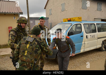 Bulgarisch und Tschechische Soldaten treffen Offizier die afghanische Nationalpolizei, während eine militärische Berater Team (MAT) und Polizei-Berater-Team (PAT) Übung auf der Joint Multinational Readiness Center in Hohenfels Trainingsbereich, Deutschland, 24. März 2014 durch eine zivile Role-player repliziert.  Die Absicht der Übung ist, Matten und Streicheleinheiten für den Einsatz in Afghanistan vorzubereiten, mit der Fähigkeit zu trainieren, zu beraten und zu ermöglichen, die afghanischen nationalen Sicherheitskräfte während besitzen die Fähigkeiten, um auf dem Schlachtfeld zu überleben. (US Armee-Foto von Spc. Wayne Becton/freigegeben) Militärische Berater Stockfoto