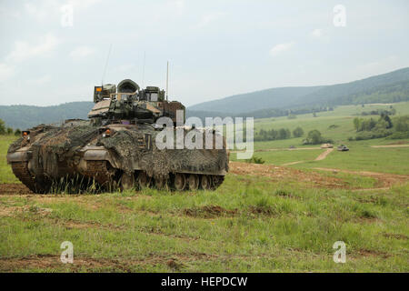 US-Soldaten von Alpha Company, 3. kombiniert Arme Bataillon, 69. Armor Regiment, 1st Armored Brigade Combat Team, 3. US-Infanteriedivision bieten Sicherheit und Scannen Sie den Bereich für die Gegenkräfte in ein M3 Bradley kämpfen Fahrzeug während eines Konvois Manöver über ein Feld während der Übung kombiniert zu beheben IV bei der US Army Joint Multinational Readiness Center in Hohenfels, Deutschland, Mai 21 , 2015.  Kombinierte Lösung IV ist eine Armee Europa gerichtet Übung training eine multinationale Brigade und Verbesserung der Interoperabilität mit Verbündeten und Partnerstaaten. Resolve Züge auf einheitliches Land Operationen kombiniert ein Stockfoto
