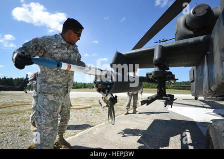 US Army Spc. Frank Walker, 2nd Battalion, 159. Angriff Reconnaissance Regiment, 12. Combat Aviation Brigade zugewiesen lädt Munition in einem AH - 64D Apache Longbow während einer Antenne Schießwesen bei der 7. Armee gemeinsame multinationale Ausbildung des Befehls Truppenübungsplatz Grafenwöhr, Deutschland, 5. August 2015. (US Army Foto von visuellen Informationen Spezialist Gertrud Zach/freigegeben) 2-159 ARB, 12. Kabine führen aerial Gunnery 150805-A-HE359-007 Stockfoto