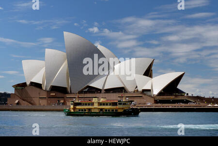 Das Sydney Opera House ist ein Multi-Veranstaltungsort Performing Arts Centre in Sydney, New South Wales, Australien. Am Bennelong Point im Hafen von Sydney, in der Nähe von der Sydney Harbour Bridge, befindet sich die Anlage neben dem Sydney central Business District und den Royal Botanic Gardens, Sydney bis Bauernhof Buchten.  Entworfen vom dänischen Architekten Jørn Utzon, die Anlage offiziell eröffnet am 20. Oktober 1973, von Königin Elizabeth II, mit Mitgliedern der britischen Königsfamilie in Anwesenheit nach eine Schwangerschaft beginnt mit Utzons 1957 Auswahl als Sieger eines internationalen Design-Wettbewerbs. Die veröff. Stockfoto