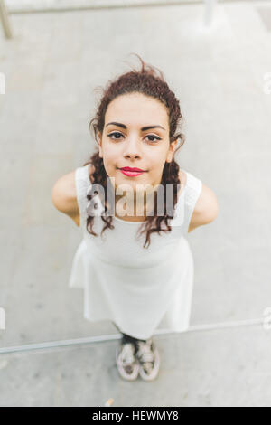 Hohen Winkel Porträt Frau, Hände hinter Rücken Blick in die Kamera Stockfoto
