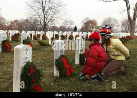 Ein kleiner Junge und seine Mutter bezahlen ihren Respekt zu den Grabstein eines gefallenen Dienst während einer Kranzniederlegung Zeremonie auf dem Arlington National Cemetery, Dez. 11. Diese Familie war einer der Tausenden anwesend, die halfen insgesamt 24.000 Kränze zu legen, um sicherzustellen, dass diejenigen, die das ultimative Opfer in Kriegszeiten gab während der Feiertage nicht vergessen werden. Tausende von Service-Mitglieder, Pamilien trotzen Kälte helfen gefallene Helden DVIDS351763 zu Ehren Stockfoto