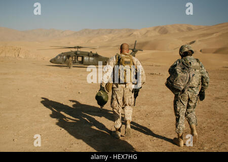 Command Sergeant Major Bryan Link, Special Operations Task Force-West und International Security Assistance Force Befehl Sergeant Major, Marvin L. Hill, gehen Sie in Richtung ein UH-60 Blackhawk Hubschrauber bei einer Koalition Basis in das Dorf von Darrah-ich-Bum, Provinz Badghis, Afghanistan 4. Januar 2011. Command Sergeant Major und ein Kader von Personal gehört eine kurze Sicherheit auf der Dachterrasse-Lage mit Blick auf das Tal. Der Auftrag war Teil eines Marines, Matrosen und Soldaten der Special Operations Task Force-West lebt und arbeitet in Darrah-ich-Bum-Besuches. (US-Marine Foto von Sgt. Brian Kester) (Release Stockfoto