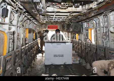 Sgt. Marcus Galvan, Crewchief mit Marine schwere Hubschrauber Geschwader 362, 3rd Marine Aircraft Wing (vorwärts), drückt eine Cargo-Box an der Vorderseite des CH-53D während einer Mission allgemeine Unterstützung.  HMH-362 transportiert Koalitionstruppen, lokale Afghanen, afghanische Nationalpolizei, Zivilisten und jede Art von Ladung, die das Flugzeug heben kann. E28098Ugly AngelsE28099 Gewicht in Kampfhandlungen DVIDS356285 Stockfoto