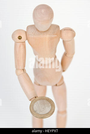 Gegliederte Mannequin hält eine 1-Euro-Münze Stockfoto