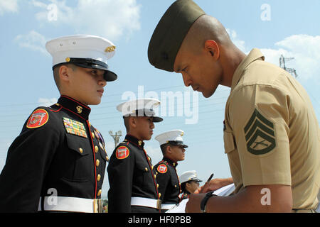 Kadetten der Kubasaki High School Marine Corps Junior Reserve Officer Training Corps werden von Staff Sgt Junior E. Diaz während JROTC Fernost Bohrer Wettbewerb 2012 auf der Kadena Air Base, 26-28. März inspiziert. Kubasaki Team verdient den Titel des 2012 JROTC Fernost Bohrer Champions der Abteilung der Verteidigung Bildung Aktivität Pacific nach dem Wettkampf gegen 11 andere Pazifikregion JROTC Maßeinheiten aus Heer, Marine und Luftwaffe. "Drill erfordert viel mehr Engagement als irgendeine andere Sportart in der High School," sagte Cadet Lieutenant Colonel Emmanuelle Cordero, Kursleiter und Kadett Bataillonskommandeur des Teams. Stockfoto