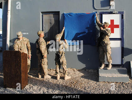 Bereiten Sie Sgt. Randy S.N. Reyes, rechts, und Spc. Crystal A. Stewart, Mitglieder der Delta Company, 1. Bataillon, 294th Infanterie-Regiment, Guam Army National Guard, sich ein neuen Zeichen zu Ehren Navy Petty Officer 2 Anthony Carbullido in Camp Stone Truppe medizinische Klinik (TMC) in der Provinz Herat, Afghanistan zu enthüllen. Carbullido starb 2008 und die Klinik wurde nach ihm benannt. Niemand aus der Guam-Guard wusste davon, bis sie es stolperte kurz nach der Ankunft im Camp Stein im Mai. (US Army National Guard Foto/freigegeben) Verloren, dann fand 130820-Z-WM549-001 Stockfoto