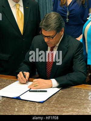 Texas-Gouverneur Rick Perry unterzeichnet feierlich Senat Bill 162 des Texas State Capitol in Austin, Texas, 28. August 2013. Senatsvorlage 162 erfordert staatliche Stellen, die am Arbeitsplatz Lizenzen um Probleme am Arbeitsplatz Lizenzen von anderen Ländern - einschließlich der Streitkräfte - zu erkennen und für die beschleunigte Zulassung für militärischen Service-Mitglieder, Ehepartner und Veteranen. (U.S. Air National Guard Foto von Staff Sgt. Phil Brunnen/freigegeben) Rick Perry unterzeichnet Chris Kyle Bill Stockfoto