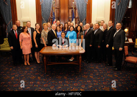 Texas-Gouverneur Rick Perry (sitzend) ist umgeben von Gesetzgeber und Unterstützer der Senat Bill 162, nachdem er die Gesetzgebung des Texas State Capitol in Austin, Texas, 28. August 2013 feierlich unterzeichnet. Texas-Gouverneur Rick Perry bereitet sich feierlich Senat Bill 162 des Texas State Capitol in Austin, 28. August 2013. Senatsvorlage 162 erfordert staatliche Stellen, die am Arbeitsplatz Lizenzen um Probleme am Arbeitsplatz Lizenzen von anderen Ländern - einschließlich der Streitkräfte - zu erkennen und für die beschleunigte Zulassung für militärischen Service-Mitglieder, Ehepartner und Veteranen. Die Rechnung der Autor Stockfoto