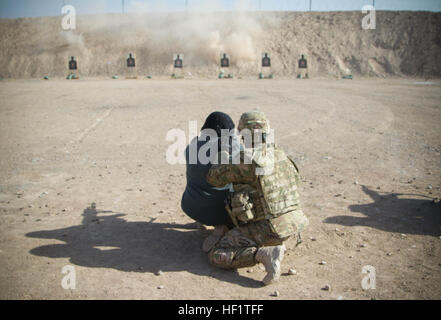 Sgt. 1. Klasse Sherise Stephens, Kandahar Haft Wiese Unteroffizier verantwortlich, 551st Military Police Company, fungiert als ein Spektrum Safety für weibliche afghanische Nationalpolizei Rekrut, wie sie mit einem Gewehr AK-74, 7. Dezember 2013, bei Regional Training Center - Kandahar, Afghanistan qualifiziert. Die ANP-Rekruten mit der AK-74 im Rahmen eines achtwöchigen Training-Kurs für weibliche Rekruten ANP qualifiziert.  (US Armee-Foto von CPL. Mariah beste) Neue Ära der afghanischen nationalen Sicherheitskräfte bereit für die Herausforderung 131207-Z-TF878-620 Stockfoto