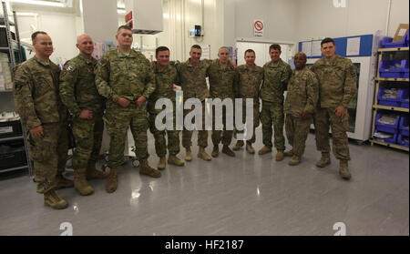 Betrieb die richtige Ausfahrt Teilnehmer posieren für ein Foto mit Soldaten, die in den OP-Saal des Camp Bastion Krankenhaus in der Provinz Helmand, Afghanistan, 13. März 2014 zu arbeiten. Betrieb richtige Ausfahrt ist ein Programm für verwundete Militärangehörige, die beschließen, nach Afghanistan zurückkehren, nach der Genesung von Kampf gegen Verletzungen um Schließung zu finden. Verwundete Soldaten zurück nach Afghanistan für Betrieb richtige Ausfahrt 140313-M-JD595-7702 Stockfoto