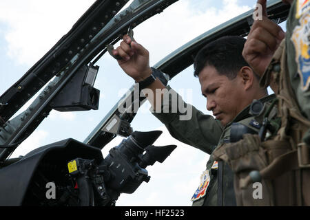 Philippine Air Force major Ferdinand Liwag bekommt in das Cockpit eines Hubschraubers, AH-1W Super Cobra orientiert, bevor eine Einarbeitung Flug während Balikatan, auf der Clark Air Base, Philippinen, 12. Mai 2014. In seiner 30. Iteration ist Balikatan einen jährlichen Übung, die die Interoperabilität zwischen der Streitkräfte der Philippinen und US-Militär in ihrem Engagement für regionale Sicherheit und Stabilität, humanitäre Hilfe und Katastrophenhilfe stärkt. Liwag ist ein MD-520 Militär Kampfhubschrauber Pilot mit der 18. Angriff Geschwader, 15. Strike Wing. (U.S. Marine Corps Foto von Lance Cpl. Abbey Stockfoto