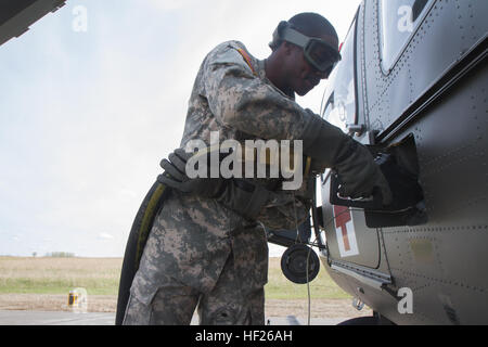 Colorado Army National Guard Spc. Davionn Johnson, ein Fueler für das 2. Bataillon, 135. General Support Aviation, tankt ein UH-72 Lakota Hubschrauber als Teil der Übung Maple lösen im kanadischen Manöver Training Center in Wainwright, Alberta, 20. Mai 2014. Oberste Führung besucht der kanadischen Manöver Training Center in Wainwright, Alberta, während Colorado Army National Guard Luftfahrt Ressourcen an Übung Maple lösen 2014 (EXMR14) vom 5. Mai bis 1. Juni 2014. Ca. 5.000 kanadischen, britischen und US-amerikanischen Truppen beteiligen sich an der größten jährlichen Übung von der Stockfoto