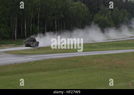 Ein Bradley Schützenpanzer zugewiesen, die 1. Brigade Combat Team, 1. Kavallerie-Division, bewegt sich schnell von einer Feuerstellung zu einem anderen bei der US-Armee gemeinsame multinationale Training Command Trainingsgelände in Grafenwöhr, Deutschland, 12. Juni 2014. Dies ist das erste Mal die 1st Brigade Combat Team, 1. Kavallerie-Division, trat Gunnery Training mit den europäischen Aktivität festgelegt. Die EAS ist ein Bataillon mittlere Gruppe von gepanzerten Fahrzeugen und Geräten bei der US-Armee gemeinsame Multinational Training Command in Grafenwöhr, Unterstützung und Outfit US Army Rotations Forc vorpositioniert Stockfoto