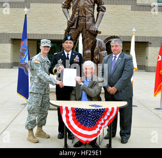 Gouverneur Rick Snyder hält House Bill 5451 nach Unterzeichnung der Rechnung bei der Michigan National Guard Joint Force Headquarters in Lansing, Michigan, 1. Juli 2014. Halten die Rechnung mit den Gouverneuren sind Unternehmen B, 1. Bataillon, 125. Infanterie Soldat Private 1. Klasse Ian Cunningham und Michigan Adjutant General Generalmajor Gregory Vadnais. Auch abgebildet ist Rep Bruce Renden, der Gesetzentwurf Sponsor. Der Gesetzentwurf sieht Studiengebühren Unterstützung für Michigan Guard Mitglieder in gutem ansehen. (Foto: Michigan National Guard Master Sgt. Denice Rankin) Gouverneur Rick Snyder unterzeichnet Nationalgarde Nachhilfe Hilfe Bill (14426 Stockfoto