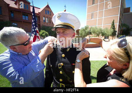 Die Eltern der Colin R. Caskey pin Rang Abzeichen auf ihren Sohn, ein neu in Betrieb genommenen United States Marine Corps 2. Leutnant während Caskey der Inbetriebnahme Zeremonie im Old Main an der Arizona State University in Tempe, Arizona, 15. September 2014. Caskey, gebürtig in Scottsdale, Ariz, und 2009 Absolvent Brophy College vorbereitende in Phoenix, absolvierte ASU im Mai mit einem Bachelor-Abschluss in Business Management. Caskey verdient seine Provision durch die Marine Corps Platoon Führer Klasse (SPS)-Programm mit einer Luftfahrt-Option und nach der Fertigstellung von The Basic School (TBS), die er Okt. 14 beginnt, Stockfoto