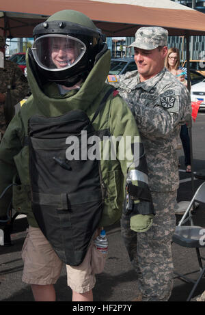 Carson Beck Lächeln durch die Explosion-Proof Gesicht Bildschirm eine explosive Ordnance Entsorgung Bombe zu entsprechen, während der ersten Gemeinschaft Exposition von Arizona National Guard bei Arizona State University Sun Devils Stadion 7. Dezember 2014, in Tempe, Arizona statt Die Expo fand unmittelbar nach der historischen Muster von Arizona National Guard Flieger und Soldaten. (Foto von Sgt. Ryan Scott US Army National Guard) Arizona-Guard Gemeinschaft Expo zeigt starke Bindungen in militärisch-zivile 141207-Z-HL120-053 Stockfoto