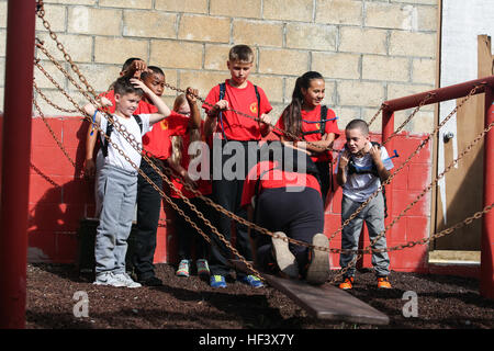 MARINE CORPS BASE HAWAII – motivieren Kinder mit dem Young Marines-Programm ihre Teamkollegen erhalten Sie auf ein Hindernis während einer Führung Reaktion, an Bord der Marine Corps Base Hawaii, 9. April 2016. Die Young Marines beteiligte sich an den Kurs zur Verbesserung der Teamarbeit und Führung untereinander. Das Young Marines-Programm ist eine nationale Non-Profit-Jugendbildung und Serviceprogramm für Jungen und Mädchen, Alter von acht Jahren durch den Abschluss der High School. (US Marine Corps Foto von Lance CPL Jesus Sepulveda Torres) Junge Marines, Teamarbeit und Führung 160409-M-ST224-057 Stockfoto