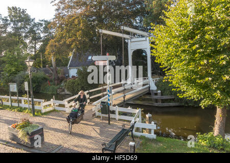 Mutter mit Kleinkind und Baby bei einem Träger Fahrrad Radfahren nach Hause in Broek in Waterland 6 km 4 Meile nördlich von Amsterdam Stockfoto