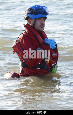 Mitglieder des Southend RNLI üben in der Nähe von Southend Beach. Sie funktionieren vom Ende des Piers aus. Das ist ein Rettungsbootmann im Meer Stockfoto