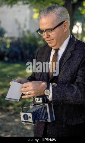 Ein Mann schält die Chemikalie sichern Weg von einer "instant" Fotoabzug, die ein frühes Modell der Polaroid Land Kamera erstellt wurde. Eingeführt im Jahre 1947 von seinem Erfinder, Dr. Edwin Land, produziert der Roman Polaroid-Kamera ein schwarz-weiß-Snapshot-Bild nur wenige Sekunden nach die Belichtung gemacht wurde. Der Peel-apart Polaroid-Film wurde von der Kamera des Fotografen gezogen, die dann den Druck von seiner chemischen bedeckten negativ trennen musste. Späteren Polaroid-Filme verwandelte sich in fertigen Farbfotos, die von der Kamera automatisch ausgeworfen wurden, nachdem ein Bild aufgenommen wurde. Stockfoto