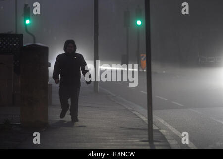 Wimbledon London, UK. 30. Dezember 2016. Ein Fußgänger geht durch dichten eiskalten Nebel in Wimbledon © Amer Ghazzal/Alamy Live-Nachrichten Stockfoto