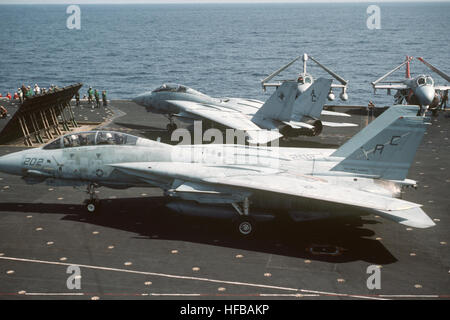 Zwei F-14A Tomcat Flugzeug Taxi auf dem Flugdeck hinter einem Jet Blast Deflektor im Flugbetrieb an Bord des Flugzeugträgers USS JOHN F. KENNEDY (CV-67).  Das Flugzeug im Vordergrund ist ab dem Fighter Squadron 32 (VF-32) und das Flugzeug im Hintergrund von Fighter Squadron 14 (VF-14). F-14 Tomcat VF-32 Stockfoto