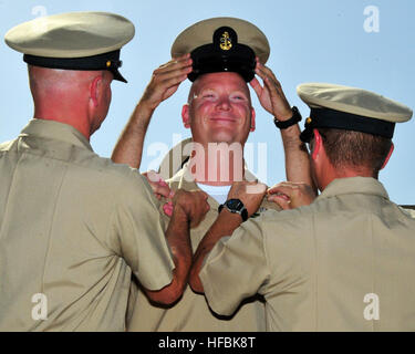 SOUDA BAY, Griechenland (14. September 2012) Chief Master-at-Arms Douglas Terou, zugewiesen an der Naval Support Aktivität Souda Bay-Sicherheitsabteilung erhält sein Chef Anker und Kombination Abdeckung aus anderen Häuptlinge während einer Zeremonie, Chief Petty Officer anheften. (US Navy Foto von Paul Farley/freigegeben) 120914-N-MO201-076 verbinden das Gespräch www.facebook.com/USNavy www.twitter.com/USNavy navylive.dodlive.mil - offizielle US Navy Bilder - neuer Chef erhält Abdeckung und Anker. Stockfoto