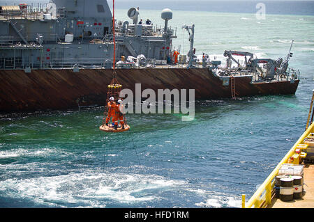 SULU-See (25. Februar 2013) Bergung Crew-Mitglieder, die US Navy zugewiesen beauftragte Schiff M/V Jascon 25 per Kran auf die Mine Gegenmaßnahmen Schiff USS Guardian (MCM 5) übertragen. Guardian strandete am Tubbataha Reef 17. Januar. Unsicheren Meere Bedingungen erlaubt keine Verpflegung des Schiffes von Festrumpf Schlauchbooten. Die US-Marine und vertraglich vereinbarten Restwert Teams weiter Schadensfeststellungen und die Beseitigung der Ausrüstungsgegenstände und Teile, bereiten die geerdete Schiff sicher abgebaut und vom Tubbataha Reef entfernt werden. Der US-Marine weiterhin in enger Zusammenarbeit mit der philippinischen Auth funktioniert Stockfoto