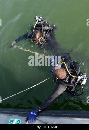 130124-N-PF210-038 MINA SALMAN PIER, Bahrain (24. Januar 2013) Navy Diver 3. Klasse Tschad Crawford, zugewiesen, Mobile Tauchen und Salvage Unit (MDSU) 2, Firma 2-2, tritt das Wasser während eines Tauchgangs Routine Anti-Terror Force Schutz. MDSU 2 ist Commander Task Group 56,1 zugeordnet, Förderung der Grube Gegenmaßnahme, explosive Ordnance Entsorgung, retten, Tauchen und Schutz in den USA zu erzwingen 5. Flotte Aufgabengebiet. (Foto: U.S. Navy Mass Communication Specialist 2. Derek R. Sanchez/freigegeben) Anti-Terror Force Protection Inspektion Tauchgang 130124-N-PF210-065 Stockfoto