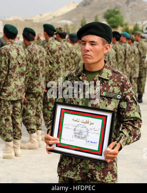 Afghan National Army Private Mohammed Khaili, der 100.000. BWC-Diplom durchlaufen, Alphabetisierung, erhält eine Plakette und Stift in Kabul Military Training Center in Kabul, Afghanistan, 28. Juli 2011, in Anerkennung der afghanischen nationalen Sicherheitskräfte Errungenschaften im Bereich der Bildung und Alphabetisierung. Grundsätzliche Krieger Ausbildung Kandak 162 absolvierte 1.287 Soldaten, all denen weiterhin militärische und Alphabetisierung in verschiedenen Afghan National Army Zweig Schulen oder konsolidiert Fielding Cener in Kabul. (Foto: U.S. Navy Petty Officer 2. Klasse Michael James/freigegeben) 100,00 Stockfoto