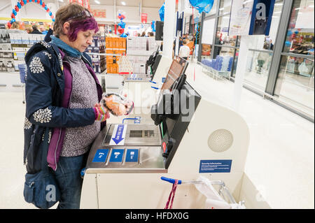Supermarktkasse: ein Frau-Shopper mit der SB-Kasse in der Tesco-Supermarkt-Superstore, Aberystwyth Wales UK (am Tag Eröffnung des Ladens 24. November 2016) Stockfoto