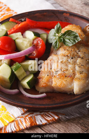 Grillen Fischfilets und Salat aus frischem Gemüse Nahaufnahme auf einer Platte. vertikale Stockfoto