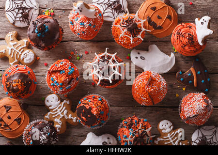 Halloween Cupcakes und Lebkuchen auf dem Tisch. horizontale Ansicht von oben Stockfoto