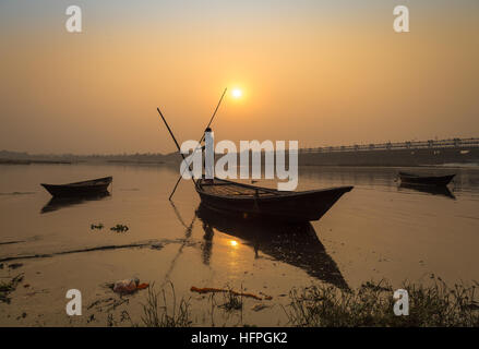 Silhouette Holzboot mit Ruderer bei Sonnenuntergang am Fluss Damodar, Durgapur Barrage, West Bengal, Indien. Stockfoto