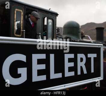 Welsh Highland Railway WHR - Dampf-Lokführer / Lokführer schaut aus der Kabine in Beddgelert auf New Years Eve 2016 Bergen im Hintergrund Stockfoto